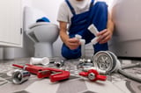 plumber working in bathroom. plumbing services