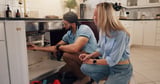 Plumber, man and woman by kitchen sink for pipe, inspection and check for leak